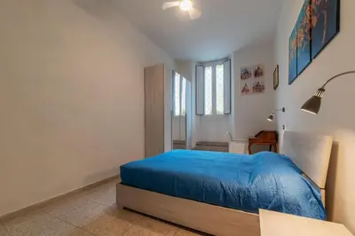 a bedroom with a blue bed in a room at GuestHost - Piazzale Clodio Apartment in Rome