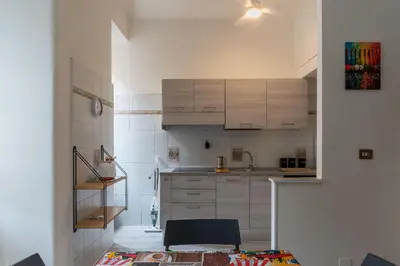 a kitchen with white cabinets and a sink at GuestHost - Piazzale Clodio Apartment in Rome