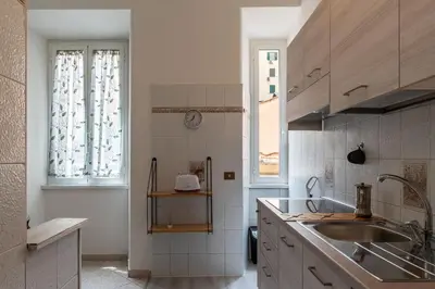 a white kitchen with a sink and a window at GuestHost - Piazzale Clodio Apartment in Rome