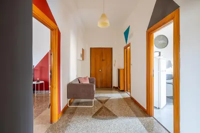 a hallway with a chair in a room at Three large bedrooms for six people Rome downtown apartment in Rome