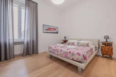 a white bedroom with a bed and a window at Life Home Vatican in Rome