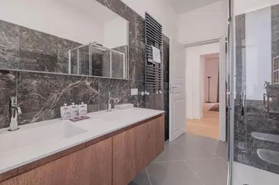a bathroom with a large sink and a shower at Life Home Vatican in Rome