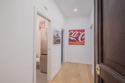 a hallway with a coca cola poster on the wall at Life Home Vatican in Rome