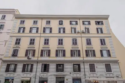 a large building with many windows on a street at Life Home Vatican in Rome