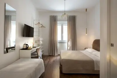a bedroom with a bed and a desk with a computer at Charme Holidays Puccini in Rome