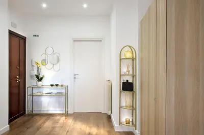 a room with a hallway with white walls and a mirror at Charme Holidays Puccini in Rome