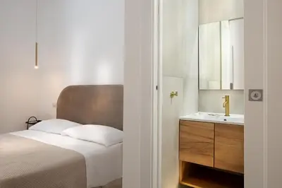 a bedroom with a bed and a sink at Charme Holidays Puccini in Rome