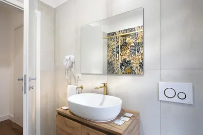 a bathroom with a white sink and a mirror at Charme Holidays Puccini in Rome
