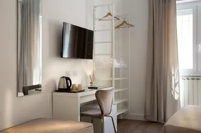 a room with a desk with a chair and a mirror at Charme Holidays Puccini in Rome