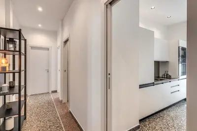 a kitchen with white walls and a glass refrigerator at Clodio Guest House in Rome