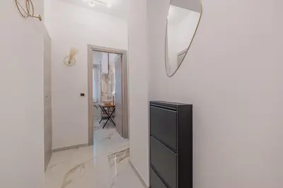 a room with a mirror and a black dresser at Petit House Roma in Rome