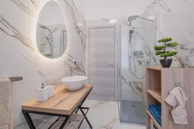 a bathroom with a sink and a shower at Petit House Roma in Rome