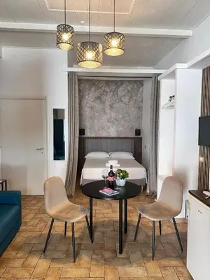 a bedroom with a bed and a table with chairs at Trasteverina Apartment in Rome