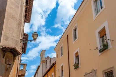 an alley in the city with buildings at Trasteverina Apartment in Rome