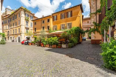 a cobblestone street in a city with buildings at Trasteverina Apartment in Rome