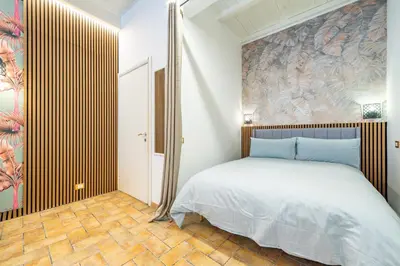 a bedroom with a bed and a wall mural at Trasteverina Apartment in Rome