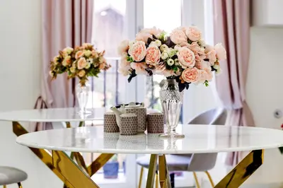 a table with two vases of flowers on it at Dimora Merulana 183 in Rome