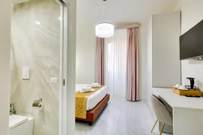 a hotel room with a bed and a shower at Dimora Merulana 183 in Rome