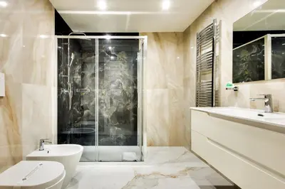 a bathroom with a shower and a toilet and a sink at Dimora Merulana 183 in Rome