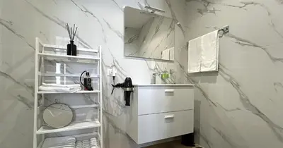 a white bathroom with a sink and a mirror at YCH-Vatican Superior Suite in Rome