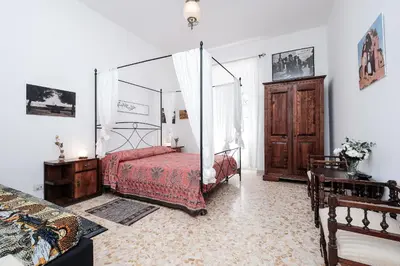 a bedroom with a bed with a canopy at Linda Apartment in Rome