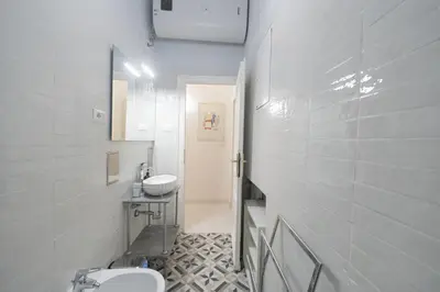 a white bathroom with a sink and a toilet at Linda Apartment in Rome
