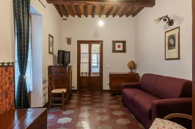 a living room with a couch and a tv at GuestHost - Stylish Apartment in the Heart of Rome in Rome