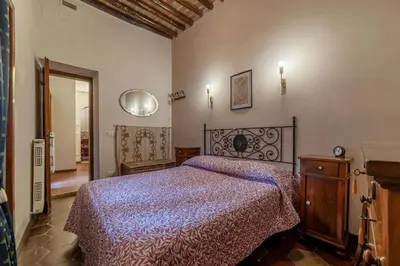 a bedroom with a bed with a purple comforter at GuestHost - Stylish Apartment in the Heart of Rome in Rome