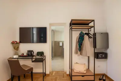 a bathroom with a sink and a bed in a room at Essence Collection Hotel in Rome