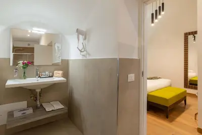 a bathroom with a sink and a shower in a room at Essence Collection Hotel in Rome