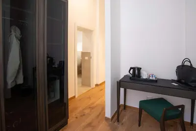 a room with a table and a chair and a mirror at Essence Collection Hotel in Rome