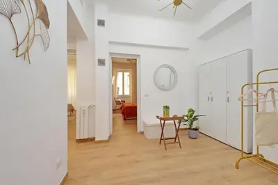 a hallway with white walls and a table in a room at Makà 32 in Rome