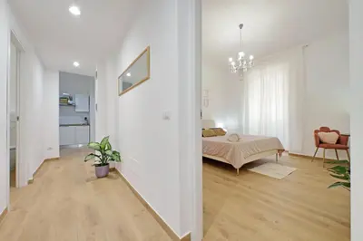 a bedroom with a bed and a living room at Makà 32 in Rome