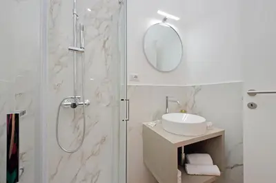 a bathroom with a shower and a sink and a mirror at Makà 32 in Rome