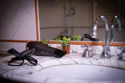 a hair dryer sitting on top of a bathroom sink at Trevi Room in Rome