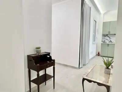 a living room with a piano and a table at Stylish Apartment near Trastevere in Rome