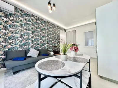 a living room with a couch and a table at Stylish Apartment near Trastevere in Rome