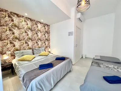 a bedroom with two beds and a wall mural at Stylish Apartment near Trastevere in Rome