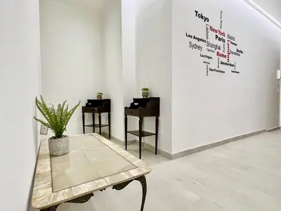 a room with a table and a wall with writing on it at Stylish Apartment near Trastevere in Rome