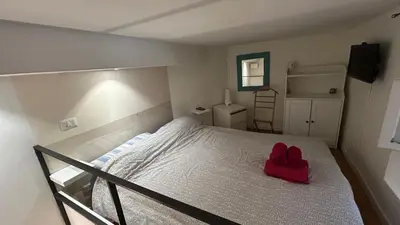 a bedroom with a bed with a red hat on it at Parioli Independent Room in Rome
