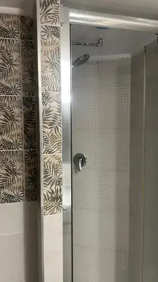 a shower with a glass door in a bathroom at Parioli Independent Room in Rome