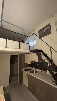 a kitchen with a sink and a staircase in a room at Parioli Independent Room in Rome