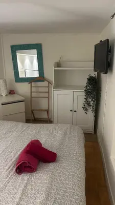 a bedroom with a bed with a red pillow on it at Parioli Independent Room in Rome