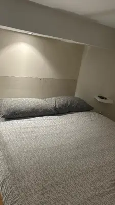 a bed in a room with a white wall at Parioli Independent Room in Rome