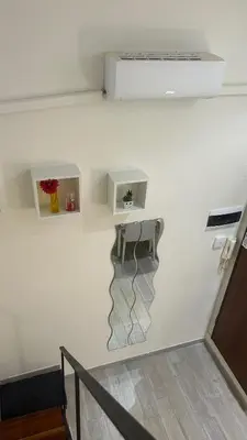 a white wall with a shelf and a stair case at Parioli Independent Room in Rome