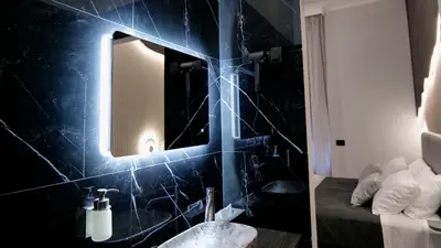 a room with a mirror on a wall at HeySuite -Luxury Vatican House- ROMA Centro Storico in Rome