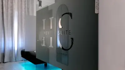 a hallway with a wall with a mural of women at HeySuite -Luxury Vatican House- ROMA Centro Storico in Rome