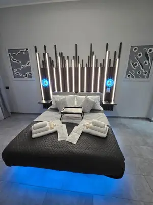 a black bed with two white towels on it at HeySuite -Luxury Vatican House- ROMA Centro Storico in Rome