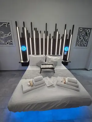 a large bed in a room with blue lights at HeySuite -Luxury Vatican House- ROMA Centro Storico in Rome