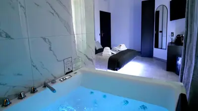 a bath tub in a room with a bedroom at HeySuite -Luxury Vatican House- ROMA Centro Storico in Rome